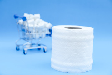Toilet paper and shopping cart isolated on a blue background