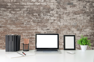 Office desk Workspace stuff with notepad, laptop and coffee cup mouse notepad shot.
