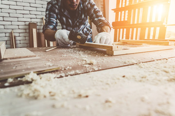 Carpenter working on wood craft at workshop to produce construction material or wooden furniture....