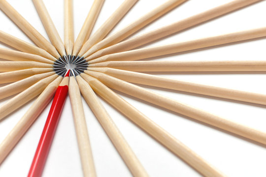 Top View Of A Red Pencil Tends To Fall Into Circle Of Gray Pencils