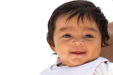 Portrait of a cute little Hispanic baby smiling.