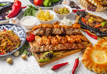 Oriental-style lunch, barbecue, fried meat, noodles with vegetables, sauces. East lunch.