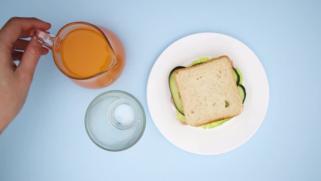 Making sandwich and pouring juice in glass for breakfast - Stop motion 