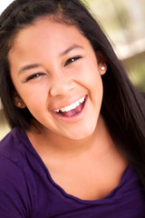 Asian teenage girl smiling.