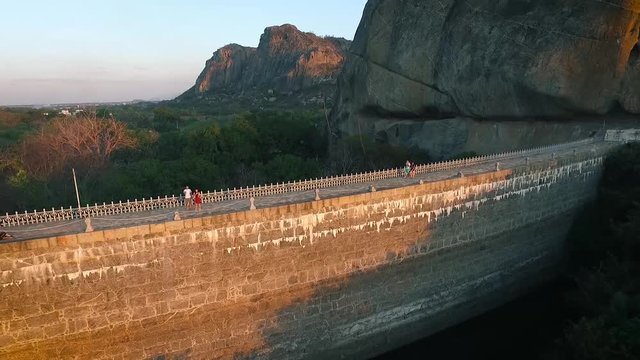 People walking in the dam of A&ccedil;ude do Cedro. This dam was the first build in Brazil. Quixada, northeast Brazil.