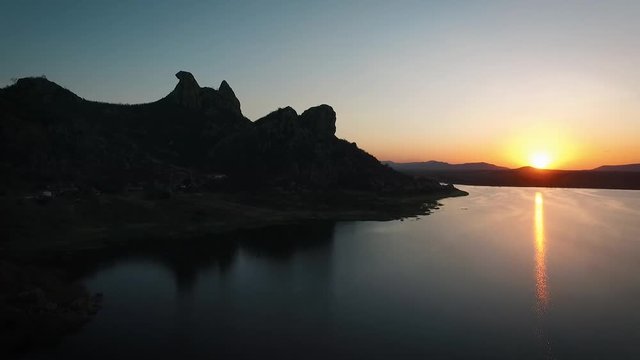 Outstandng sunset in Quixada (northeast Brazil) at the shore, and rocky mountains of A&ccedil;ude do Cedro.