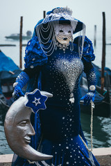 Portrait of a woman with a beautiful blue mask in Venice, Italy