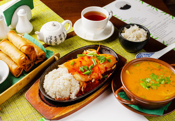 Chinese food, multi-course dinner in plates on the table
