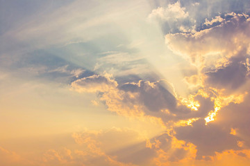 orange sunset light on blue sky with colorful sun rays