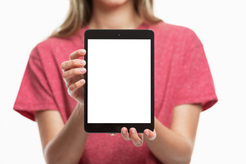 Young girl shows a tablet screen isolated. Close-up. Space for text. Front view.