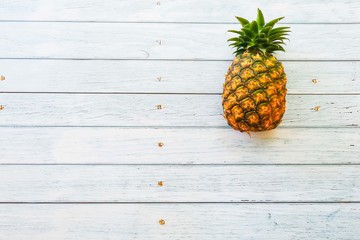Pineapple on wooden blue background with copy space