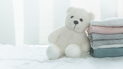 fluffy white bear doll with soft comfortable pink grey blue fabric cloth stack white cozy home...