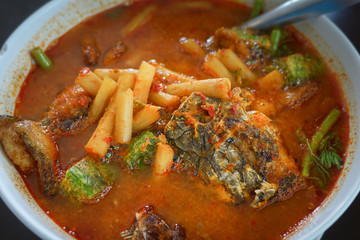 Acacia omelets and fresh shrimp in vegetable sour soup at restaurant. Deep fried cha om leaves with sour curry. Kang som cha om koong very spicy of asian traditional style.
