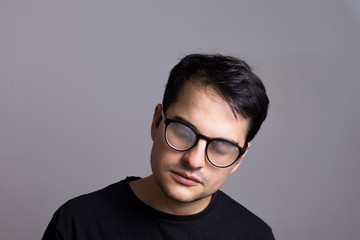 Fototapeta na wymiar Man with foggy glasses. Hipster man tired with wet glasses. Black outfit. portrait of young man