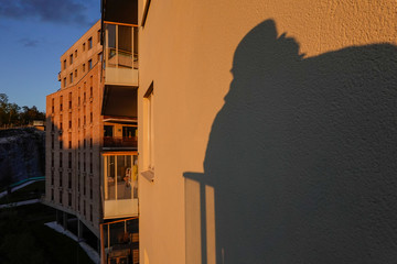 Stockholm, Sweden A shadow of a man on a balcony in a residential building in the Norra...