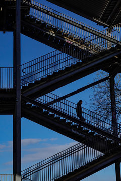 Stockholm, Sweden People walking on stairs below the Liljeholmen bridge.