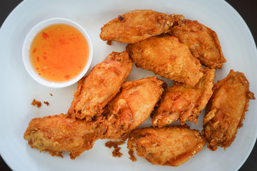Fried chicken wings on a white plate