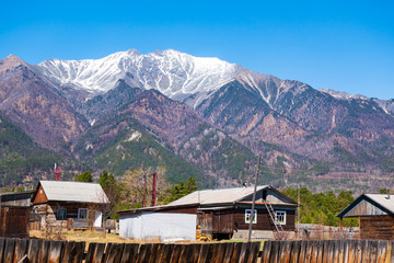 A small village at the foot of the mountains. Arshan village overlooking the mountains of the East Sayan of Buryatia. Panoramic view.