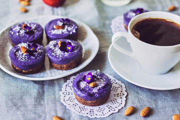 blueberry raw food cakes decorated with flowers on the table