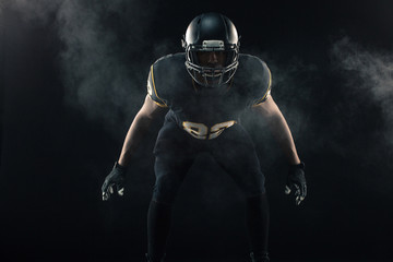 African American football player isolated on black. © digitalskillet1