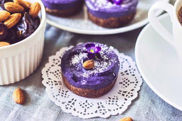 blueberry raw food cakes decorated with flowers on the table