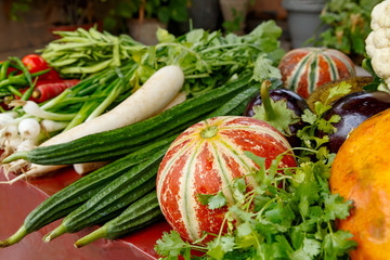 Various vegetables lying at a table in a pile