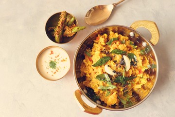 Dal khichadi/Masala Khichdi/daal khichdi tadka is a healthy Indian recipe made of mixed Lentils & rice combined with spices & vegetables. Served with Curd or Yogurt, Papad & chili pickle. Copy Space