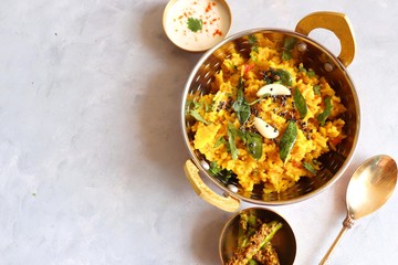 Dal khichadi/Masala Khichdi/daal khichdi tadka is a healthy Indian recipe made of mixed Lentils & rice combined with spices & vegetables. Served with Curd or Yogurt, Papad & chili pickle. Copy Space