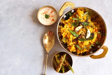 Dal khichadi/Masala Khichdi/daal khichdi tadka is a healthy Indian recipe made of mixed Lentils & rice combined with spices & vegetables. Served with Curd or Yogurt, Papad & chili pickle. Copy Space