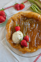 Rhubarb upside down cake with strawberries and ice cream