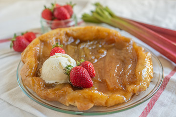 Rhubarb upside down cake with strawberries and ice cream