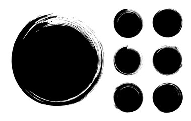 Collection of abstract brushed black ink circles with rough edges and grungy texture