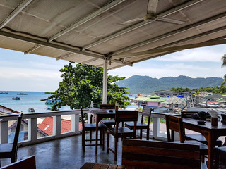 Port harbour boats ships village houses balcony restaurant seats chair view sea ocean blue beach koh tao phangha samui