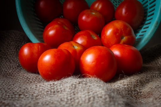 Close view of red tomatoes in heap. Fresh red tomato fruit for food background, food closeup.