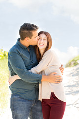 Portrait of a happy couple walking on the beach.