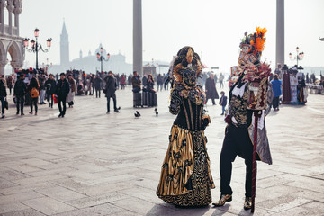 Portrait of a couple with beautiful masks in Venice, Italy