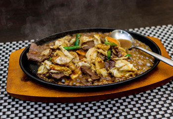 Chinese food served in a flat black plate in a restaurant in Akure