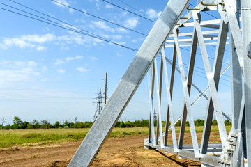 High voltage electric pillar from under. A high-voltage electricity tower