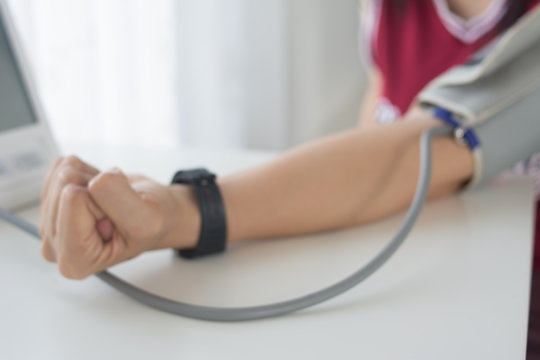 Blurred images with the idea of checking blood pressure with a doctor