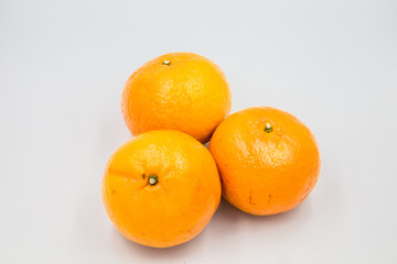 Three oranges were placed on a white ground.