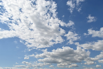White fluffy clouds on the blue sky, nature background.