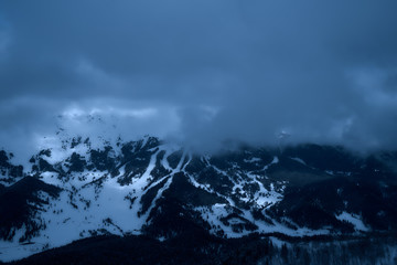 Image of a mountain covered with a snow cloud.