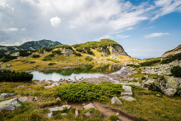 Beautiful mountain scenery - A mountain lake in a sunny day. Beauitful landscapes. Rila mountain, Bulgaria. Trekking / hiking concept.