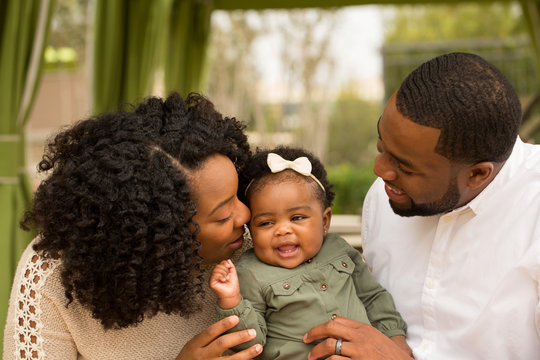 Happy African American family with their baby.