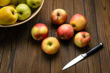 Green and red apples on wooden background