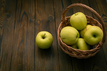 Green and red apples on wooden background