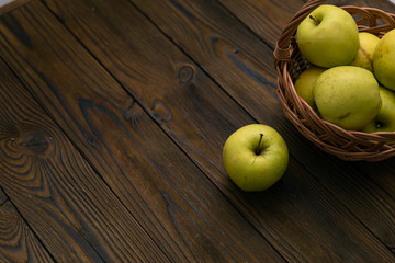 Green and red apples on wooden background