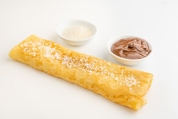 Pancake with chocolate and coconut flakes
