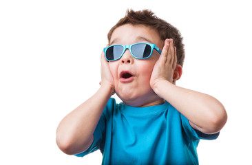 Cheerful little boy in sunglasses express surprised face, isolated on white background