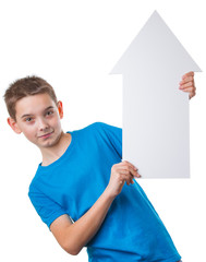 Positive boy holding a big empty white arrow and looking at camera, isolated on white background
